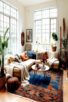 a living room filled with lots of furniture and plants on top of a wooden floor