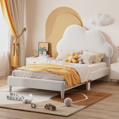 a white bed sitting in a bedroom on top of a hard wood floor