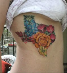 a woman's stomach with flowers painted on it and the bottom part of her belly