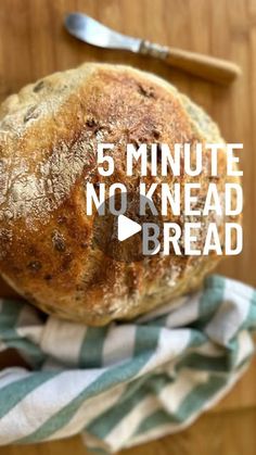 a loaf of no knead bread sitting on top of a blue and white towel