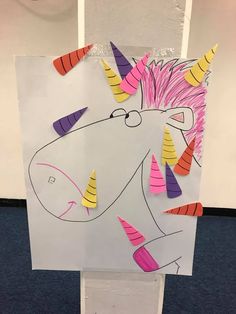 a unicorn made out of construction paper and colored crayons on the back of it