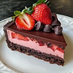 a piece of cake with chocolate and strawberries on top is sitting on a plate