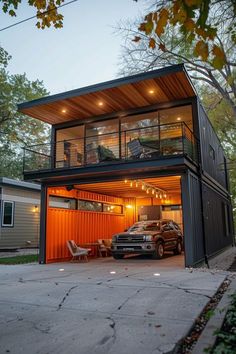 a truck is parked in front of a shipping container with its doors open and lights on