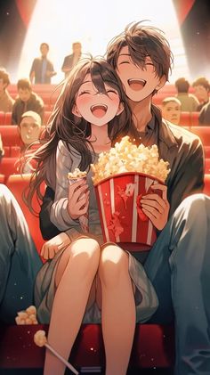 a man and woman sitting on top of a red chair in front of a movie theater