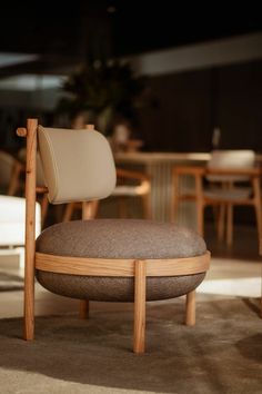 a chair that is sitting in the middle of a room with tables and chairs around it