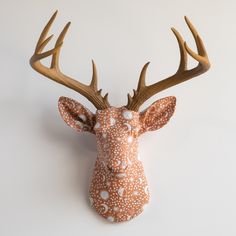 a deer head with antlers is shown on a white background, it appears to be made out of clay