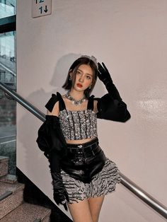 a young woman is posing on the stairs