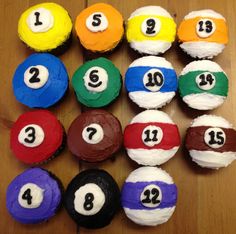 cupcakes with numbers on them sitting on a wooden table next to each other