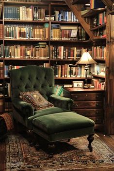 a green chair sitting in front of a bookshelf filled with lots of books