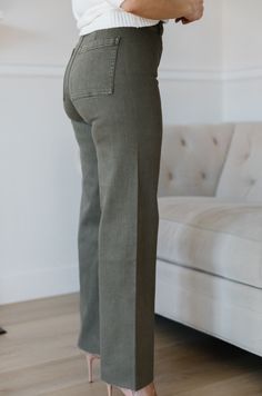 The Olive Green Wide Leg Jeans are an essential addition to any wardrobe. These classic jeans feature a flattering high waist, wide leg fit, and cropped style that flatters your figure and ensures comfort and flexibility throughout the day. Perfect for all seasons, these jeans provide timeless elegance and style. olive green wide leg pants high waist comfort stretch raw hem 98% cotton 2% spandex machine wash cold model is wearing a small SIZING CHART FOR THE JEANS: Small: fits sizing 25-26 Mediu Fall Wide Leg Straight Fit Bottoms, Everyday Wide Leg Straight Fit Pants, Straight Fit Cropped Leg Pants For Everyday, Classic Full Length Flare Jeans For Spring, Relaxed Fit Cropped Flare Jeans For Fall, Versatile Cropped Jeans With Relaxed Fit, Straight Fit Flare Jeans With Pockets For Fall, Fall Relaxed Fit Cropped Flare Jeans, Fall Cropped Jeans With Relaxed Fit