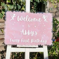 a sign that says, welcome to abys's fairy first birthday on it