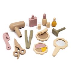 a collection of wooden toys including scissors, combs, and other items on a white surface