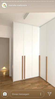 an image of a room with white cupboards and wood flooring on the walls