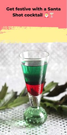 a shot glass filled with red, green and white liquid