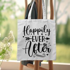 a tote bag that says happily ever after sitting on a chair next to flowers