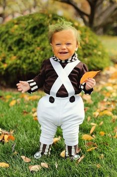 a little boy that is standing in the grass