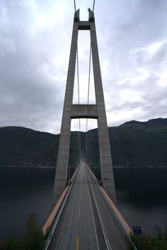 the bridge is very tall and has two lanes for cars to go over it on