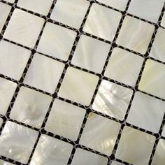 a white and black mosaic tile pattern on the floor