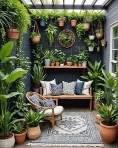 an outdoor patio with potted plants and seating on the floor, surrounded by greenery