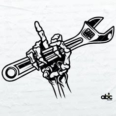 a hand holding a wrench and spanner