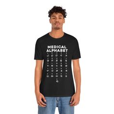 Medical Alphabet Shirt Doctor Nurse Hospital Funny Tshirt Gift for Doctors Fun Birthday Cool Unisex Jersey Short Sleeve Tee This classic unisex jersey short sleeve tee fits like a well-loved favorite. Soft cotton and quality print make users fall in love with it over and over again. These t-shirts have-ribbed knit collars to bolster shaping. The shoulders are tapered for a better fit over time. Dual side seams hold the garment's shape for longer. .: Made with 100% Airlume combed and ring-spun co Unisex Crew Neck Shirt With Letter Print, Unisex Funny Text Crew Neck Shirt, Unisex Short Sleeve Shirt With Text Print, Unisex Crew Neck Shirt With Funny Text, Basic Crew Neck T-shirt For Birthday, Unisex Basic Shirt With Letter Print, Unisex Short Sleeve Shirt With Name Print, Unisex Graphic Tee With Name Print, Unisex Letter Print T-shirt For Birthday