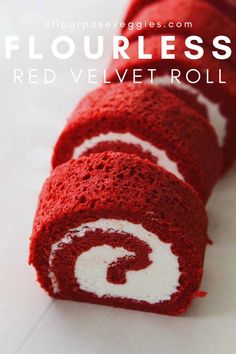 a red velvet roll with white swirls on the top and bottom is cut in half