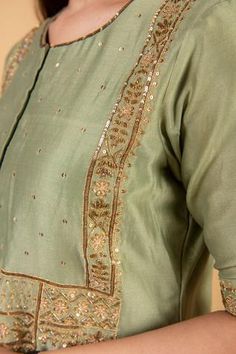 Olive green chanderi silk kurta with sequins embroidered front placket. Paired with pant in sequins embroidery along the hem.
Component: 2
Pattern: Embroidered
Type Of Work: Sequins, Floral
Neckline: Round
Sleeve Type: Short sleeves
Fabric: Chanderi silk
Color: Green
Other Details: 
Sequins embroidered cuffs and bodice
Note: Dupatta worn by model is not for sale
Occasion: Puja, Mehendi - Aza Fashions Green Slub Silk Salwar Kameez With Mirror Work, Green Salwar Kameez With Mirror Work In Slub Silk, Green Slub Silk Dupatta With Mirror Work, Mirror Work Slub Silk Palazzo Set For Festivals, Slub Silk Palazzo Set With Mirror Work For Festivals, Silk Kurta With Gota Work For Reception, Green Cotton Silk Churidar With Gota Work, Chanderi Kurta For Reception And Festivals, Pista Green Palazzo Set With Mirror Work