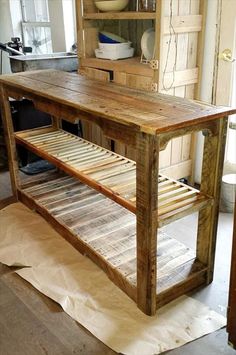 a kitchen island made out of pallet wood with an open shelf on the top