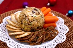 a white plate topped with meat, crackers and carrots