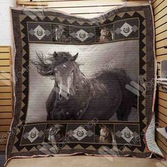 a black and white photo of a horse is displayed on a quilted wall hanging