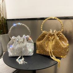 The hottest bucket bag we ever saw. Available in silver or gold. Elegant Rhinestone Bucket Bag, Elegant Bucket Bag With Rhinestones, Chic Gold Bucket Bag For Evening, Trendy Top Handle Bucket Bag For Party, Elegant Party Bucket Bags, Luxury Rectangular Bucket Bag For Party, Evening Bucket Bag With Rhinestones, Evening Bucket Bags With Rhinestones, Gold Rectangular Bucket Bag For Evening