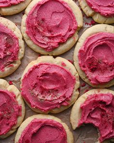 some cookies with pink frosting on top of them