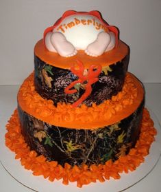 a three tiered cake decorated with an orange and white frosting baby's name