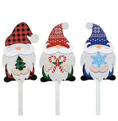 three santa claus lollipops are sitting on top of each other