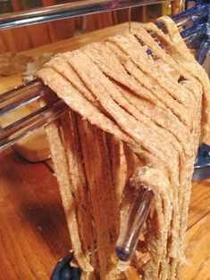 a piece of bread that is being made on a machine with some kind of wire attached to it