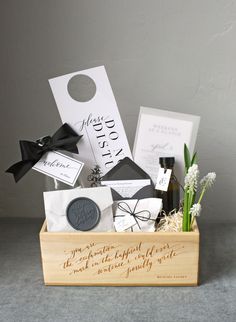 a wooden box filled with different types of wedding gift items and wine bottle in it