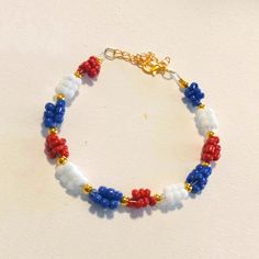 Handmade Red, White & Blue Beaded Bracelet With Gold Accents Multicolor Round Beads Bracelet For 4th Of July, Red Beaded Bracelets For 4th Of July, Multicolor Beaded Bracelets For 4th Of July, Patriotic Red Beaded Bracelets, Patriotic Blue Bracelets For Beach, Blue Jewelry For 4th Of July Beach Day, Handmade Multicolor Beaded Bracelets For 4th Of July, Handmade Multicolor Bracelets For 4th Of July, Handmade Patriotic Blue Beaded Bracelets