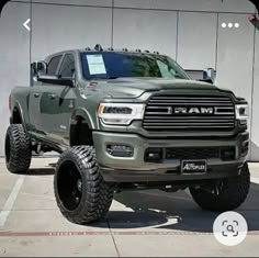 a large gray truck parked in front of a building