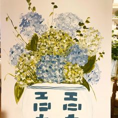 a painting of blue and white hydrangeas in a vase on a wooden table