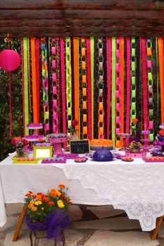 the table is covered with colorful ribbons and decorations