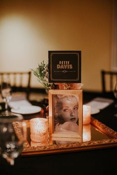 a table with candles and pictures on it