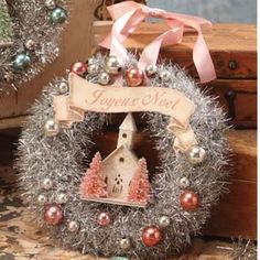 a small christmas wreath with ornaments around it