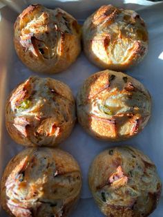 several baked goods sitting in a white tray