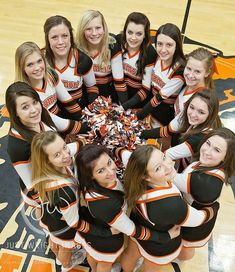 a group of cheerleaders standing in a circle