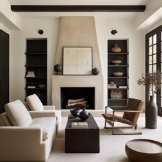 a living room filled with furniture and a fire place in the middle of a room