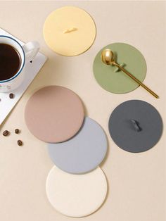 various coasters with coffee and spoon on table