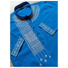 a blue shirt with white designs on it