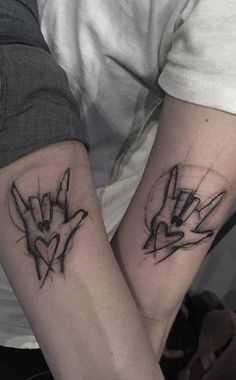 two people with matching tattoos on their arms