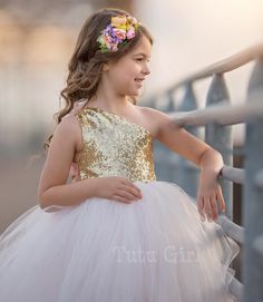 "Our exclusive signature design to Tutu Girl is our asymmetrical style dress. Showcasing gold sequins and a pale blush tulle skirt. We also offer off white (light ivory), and true ivory, among other colors. The top of the dress is FULLY LINED and the top of the strap opens to tie with a ribbon strap. The back of the dress is stretchy elastic along the top hem. Sequin fabric is only in the front. Straps ties on the right shoulder. Do you want a different color skirt or bodice color? NO PROBLEM! W Blush Tulle Skirt, Birthday Tutu Dress, Gold Tulle, Tulle Tutu Dress, Tulle Flower Girl Dress, Tulle Dresses, Girls Tutu Dresses, Flower Girl Dresses Tutu, Girl Tutu