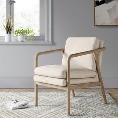 a chair sitting on top of a rug next to a window